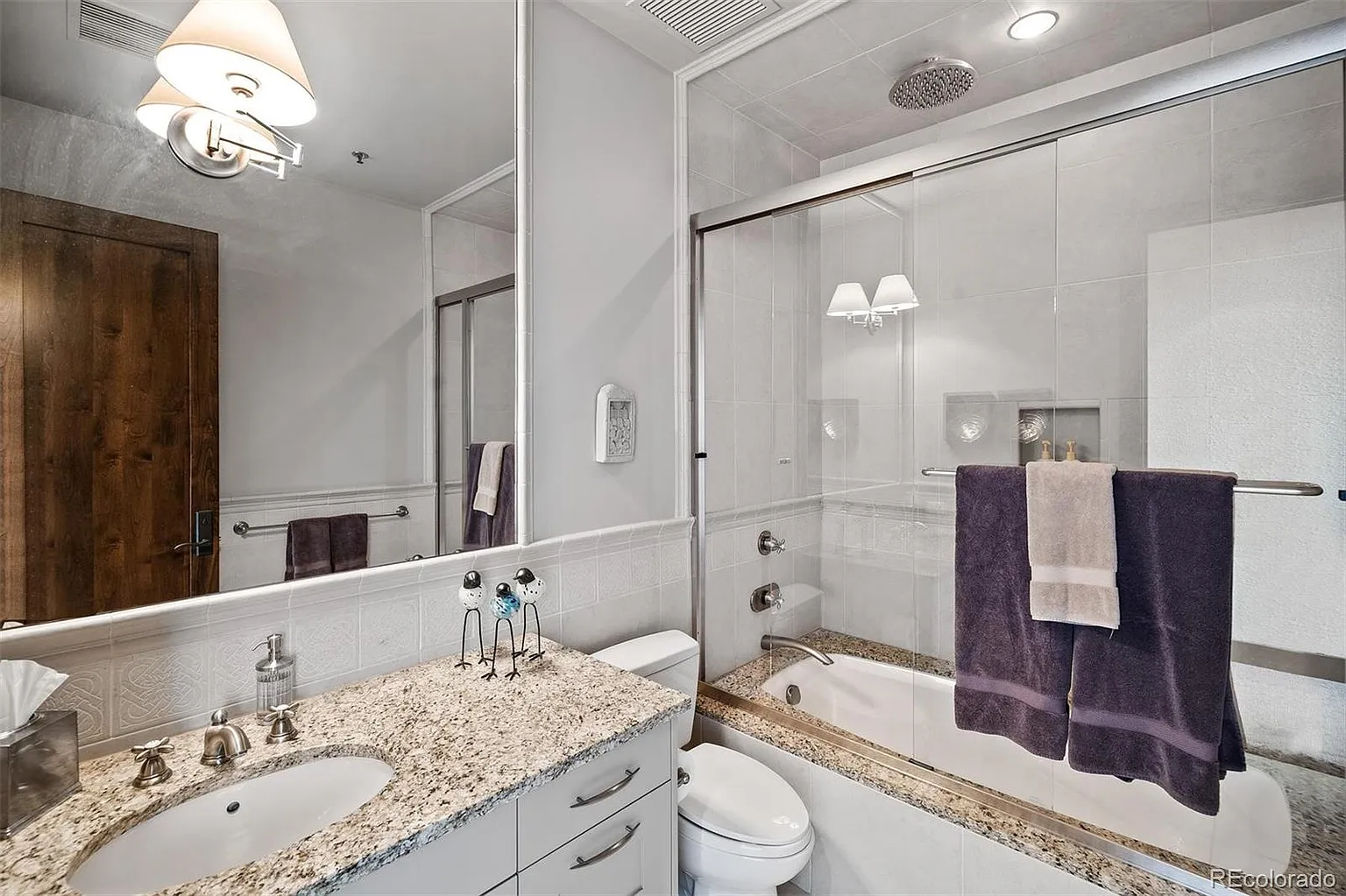 Full bathroom with granite vanity and tub-shower