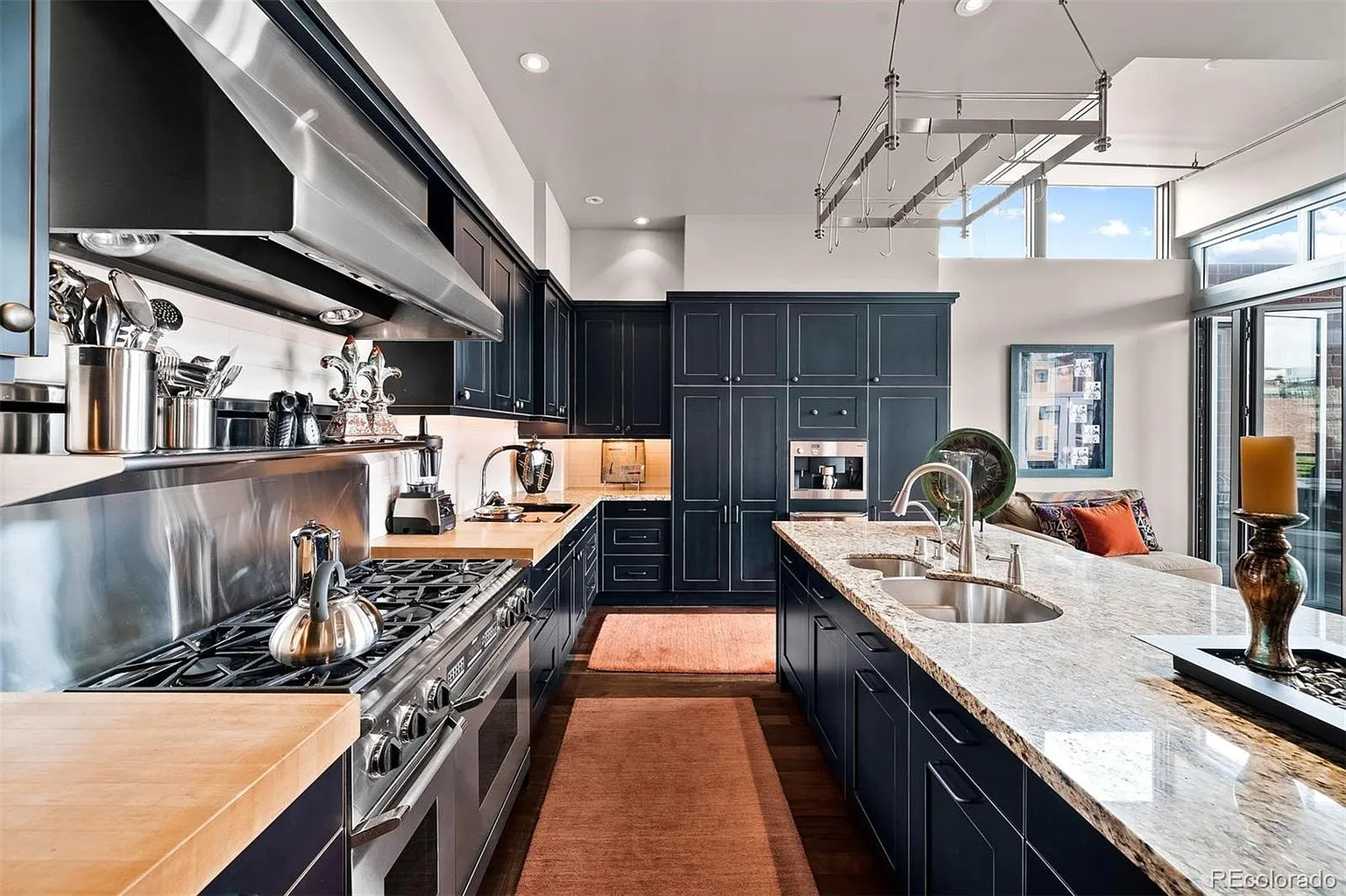 Kitchen with professional stainless range, hood, and butcher-block counters