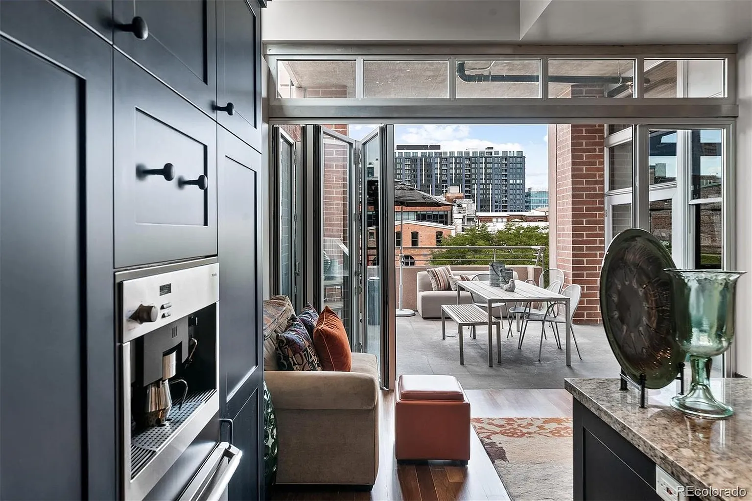 Private covered terrace with outdoor dining and city views
